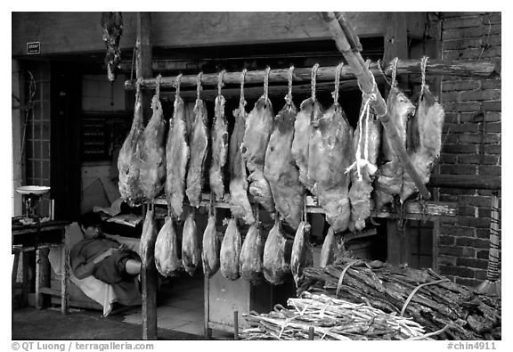 Ham made with cattle legs, salted when raw, and dried under the sun. Kunming, Yunnan, China (black and white)