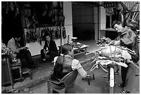 Loading roasted meat on a bicycle. Kunming, Yunnan, China (black and white)