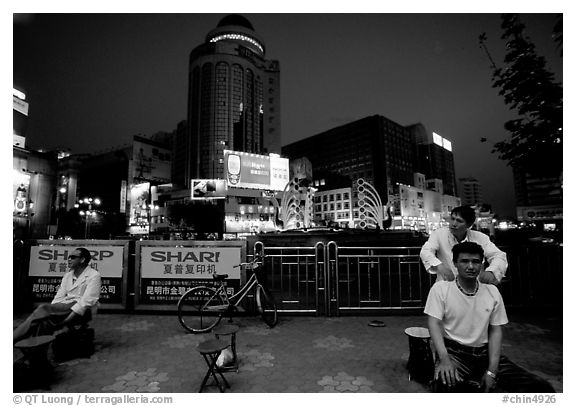 Public massage on the traffic square at  the intersection of Zhengyi Lu and Dongfeng Lu. Kunming, Yunnan, China