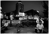 Public massage on the traffic square at  the intersection of Zhengyi Lu and Dongfeng Lu. Kunming, Yunnan, China (black and white)