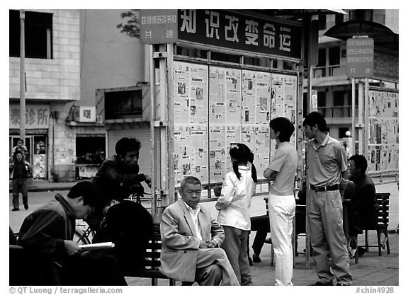 Reading dazibao (public newspapers). Kunming, Yunnan, China