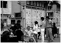 Reading dazibao (public newspapers). Kunming, Yunnan, China ( black and white)