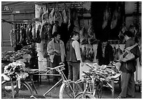 Loading roasted meat on a bicycle. Kunming, Yunnan, China (black and white)