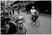Woman on bicycle in an old backstreet. Kunming, Yunnan, China ( black and white)
