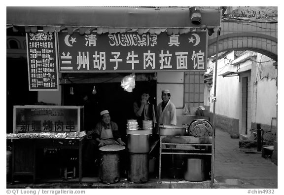 Muslim cooks at restaurant storefront. Kunming, Yunnan, China (black and white)