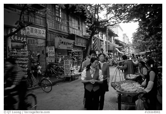 Street vendors in an old street. Kunming, Yunnan, China (black and white)