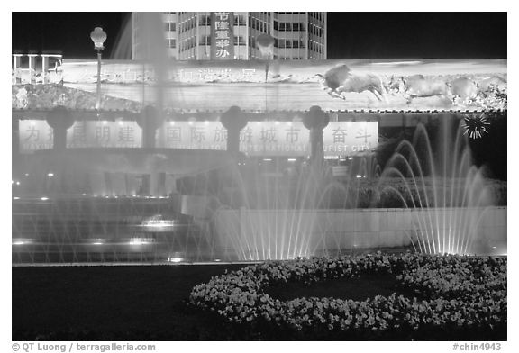 Night lights and fountains on Dongfeng Donglu. Kunming, Yunnan, China (black and white)
