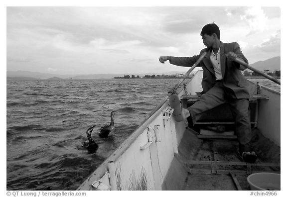 Cormorant fisherman sends out his birds. Dali, Yunnan, China (black and white)