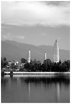 San Ta Si (Three pagodas) reflected in a lake, early morning. Dali, Yunnan, China (black and white)