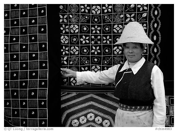 Woman in Bai dress showing drapes of traditional design. Dali, Yunnan, China (black and white)