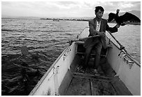 Fisherman holding a cormorant. Dali, Yunnan, China ( black and white)