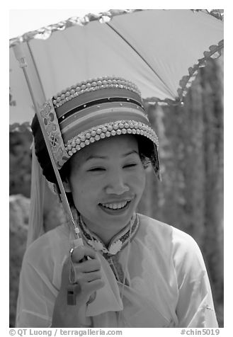 Woman from the Sani branch of the Yi tribespeople with a sun unbrella. Shilin, Yunnan, China (black and white)