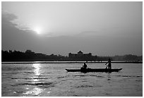 Fishermen at the confluence of the Dadu He and Min He rivers at sunset. Leshan, Sichuan, China ( black and white)