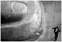 Man standing next to the toe of the Grand Buddha. Leshan, Sichuan, China (black and white)