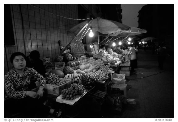 Fruit vendor, night market. Leshan, Sichuan, China