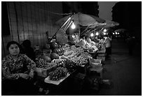 Fruit vendor, night market. Leshan, Sichuan, China (black and white)