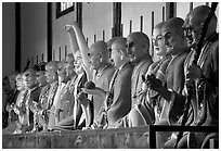 Incredible arrays of postures and expressions of some of the 1000 Terracotta arhat monks in Luohan Hall. Leshan, Sichuan, China (black and white)