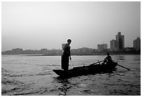 Fishermen at the confluence of the Dadu He and Min He rivers at sunset. Leshan, Sichuan, China ( black and white)