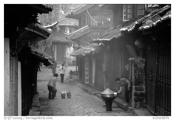 Street in the morning with dumplings being cooked. Lijiang, Yunnan, China (black and white)