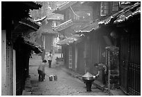 Street in the morning with dumplings being cooked. Lijiang, Yunnan, China (black and white)