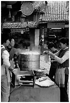 Naxi women selling dumplings and Naxi baba flatbread. Lijiang, Yunnan, China ( black and white)