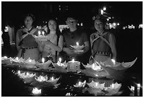 Candlelight lanters to be floated on a canal at night. Lijiang, Yunnan, China (black and white)