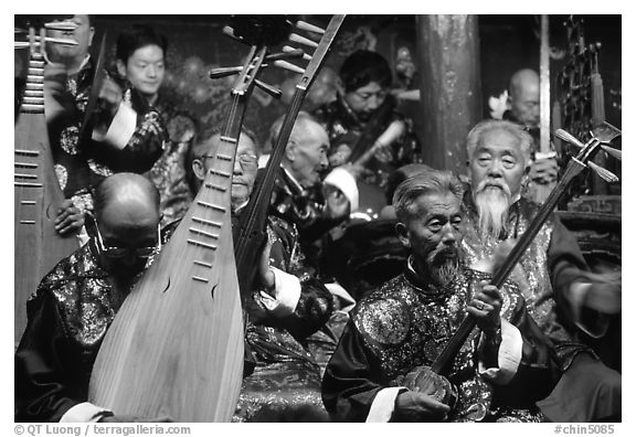 Elderly musicians of the Naxi Orchestra playing traditional instruments. Lijiang, Yunnan, China (black and white)