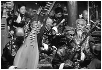 Elderly musicians of the Naxi Orchestra playing traditional instruments. Lijiang, Yunnan, China (black and white)