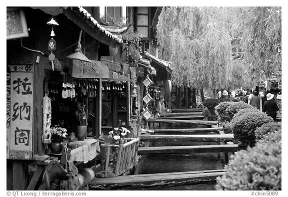 Bridges leading to restaurants and residences across the canal. Lijiang, Yunnan, China (black and white)