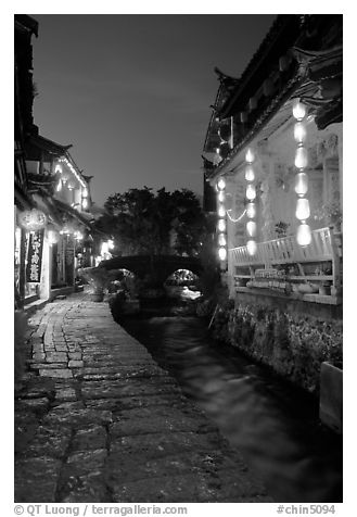 Cobblestone street and canal at night. Lijiang, Yunnan, China (black and white)