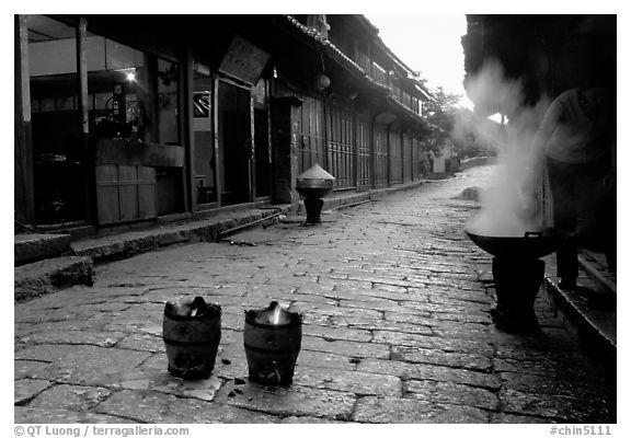 Dumplings being cooked in a cobblestone street. Lijiang, Yunnan, China (black and white)