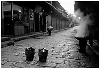 Dumplings being cooked in a cobblestone street. Lijiang, Yunnan, China (black and white)
