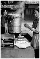 Naxi Woman preparing the baba flatbreat. Lijiang, Yunnan, China (black and white)