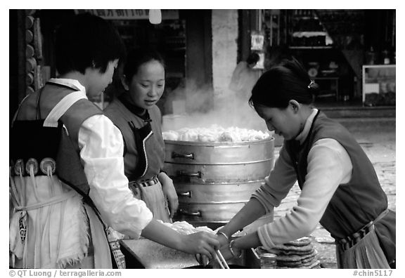 Naxi Women preparing the baba flatbreat. Lijiang, Yunnan, China (black and white)