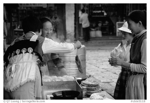 Naxi Women preparing the baba flatbreat. Lijiang, Yunnan, China (black and white)