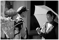 Two women conversing in the street. Lijiang, Yunnan, China (black and white)