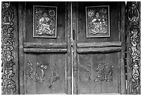 Decorated doors of a temple. Lijiang, Yunnan, China (black and white)