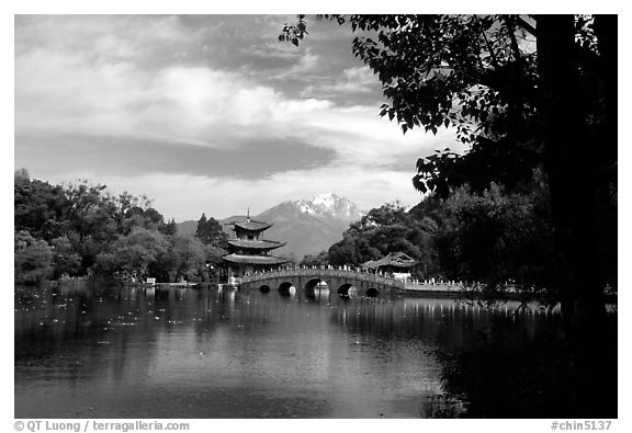 Pavillon reflected in the Black Dragon Pool, with Jade Dragon Snow Mountains in the background. Lijiang, Yunnan, China (black and white)