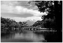 Pavillon reflected in the Black Dragon Pool, with Jade Dragon Snow Mountains in the background. Lijiang, Yunnan, China (black and white)