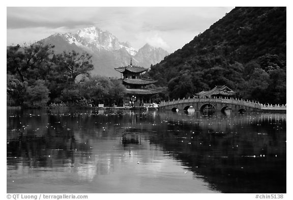 Pavillon and Jade Dragon Snow Mountains reflected in the Black Dragon Pool. Lijiang, Yunnan, China (black and white)