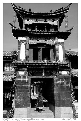 Woman under the Kegong tower archway. Lijiang, Yunnan, China