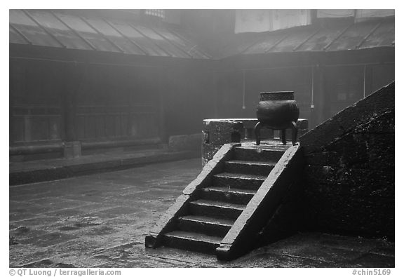 Urn and stairs in courtyard of Xiangfeng temple in fog. Emei Shan, Sichuan, China (black and white)