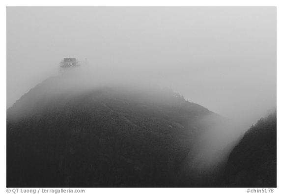 Fog sweaps over Wanfo Ding (Ten Thousand Buddhas Summit) at dusk. Emei Shan, Sichuan, China (black and white)