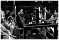 Pilgrims burning big incense batons. Emei Shan, Sichuan, China (black and white)