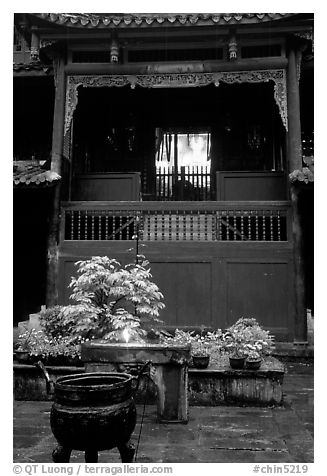 Buddha image seen from rainy courtyard of Hongchunping temple. Emei Shan, Sichuan, China (black and white)