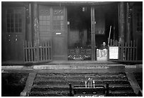 Monk looks to the courtyard inside Xixiangchi temple. Emei Shan, Sichuan, China ( black and white)