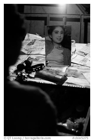 Sichuan opera actress checks her hair in a mirror. Chengdu, Sichuan, China (black and white)