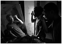 Two Sichuan opera actors apply makup before the performance. Chengdu, Sichuan, China (black and white)