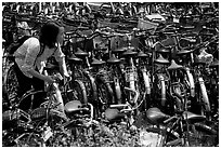 Retriving a bike in the bicycle parking lot. Chengdu, Sichuan, China (black and white)