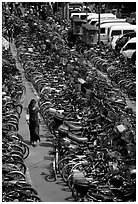 Woman walking in a bicycle parking lot. Chengdu, Sichuan, China ( black and white)